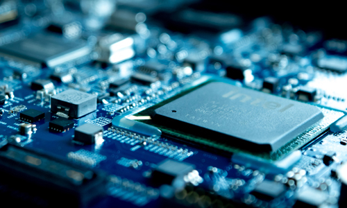 Closeup of printed circuit board with edgebond materials applied along the corners of a component.