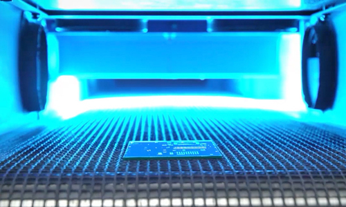 A Printed Circuit Board Coated with Conformal Coating Cures Inside a Light-Curing Conveyor System