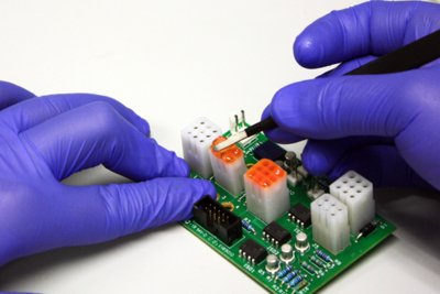 Dymax colored protective maskant being applied to printed circuit board